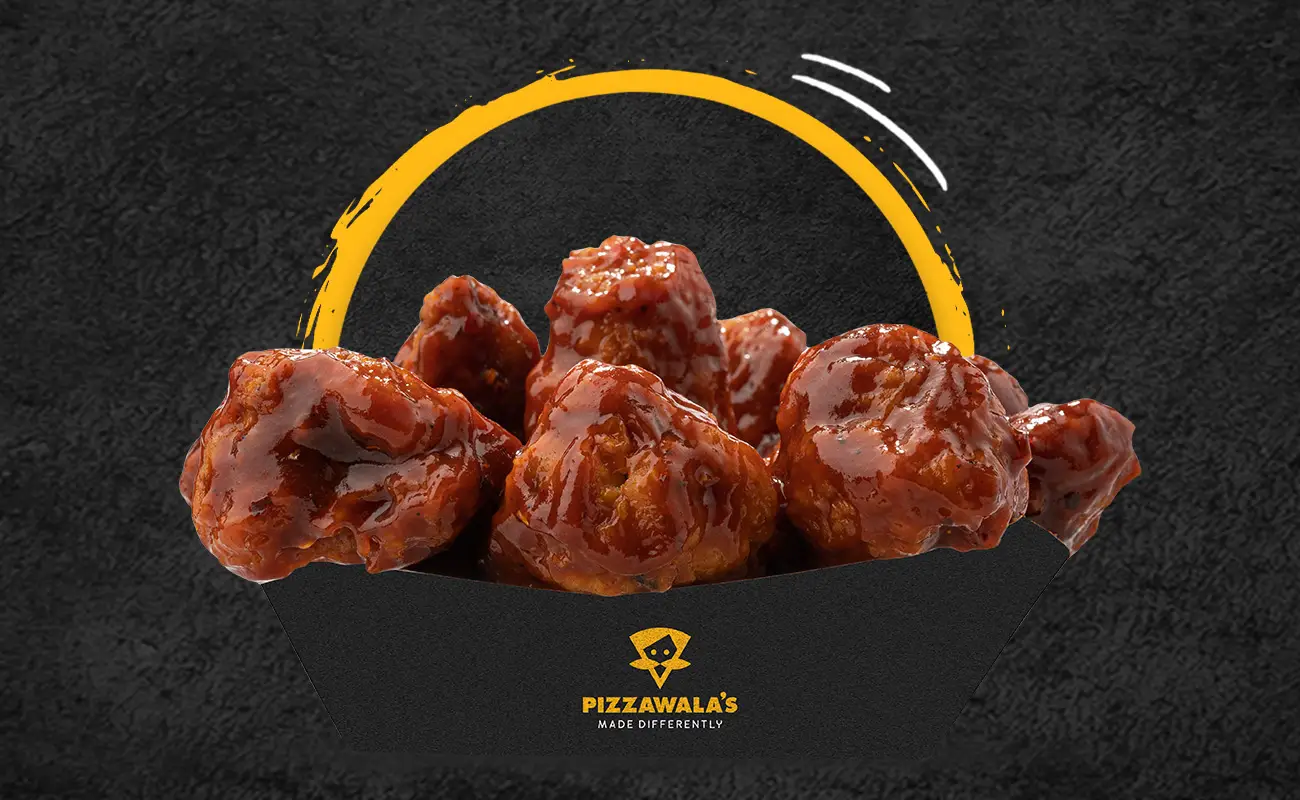 Manchurian wings Coated in a tangy, spicy Indo-Chinese Manchurian sauce with garlic, soy, and chili notes, delivering a bold, umami-packed taste.